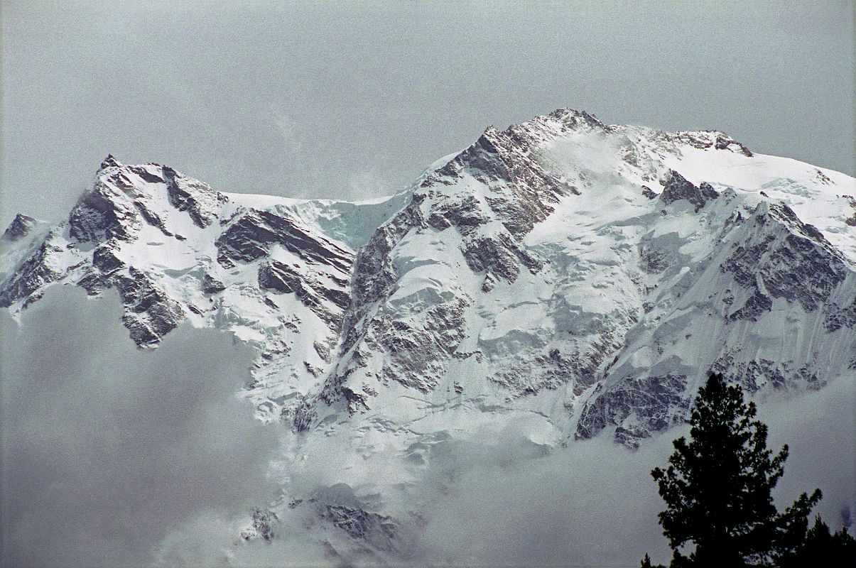 09 Nanga Parbat East Summit, Silver Saddle, North Peaks From Fairy Meadows Nanga Parbat came out of the clouds for just a few minutes at Fairy Meadows and I quickly took some photos with South East Peak (7530m) and Silberzacken East Summit (7597m), the large Silver Plateau snowfield, North Peak II (7785m), North Peak I (7816m) on the right stretching back towards the true summit (8125m).